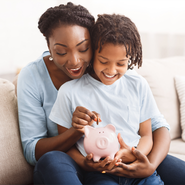 Mother and son with piggy bank